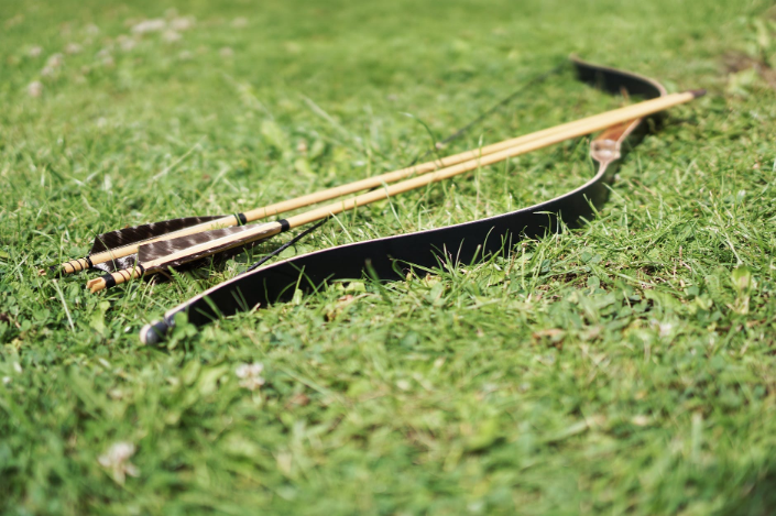 a wooden bow on the grass